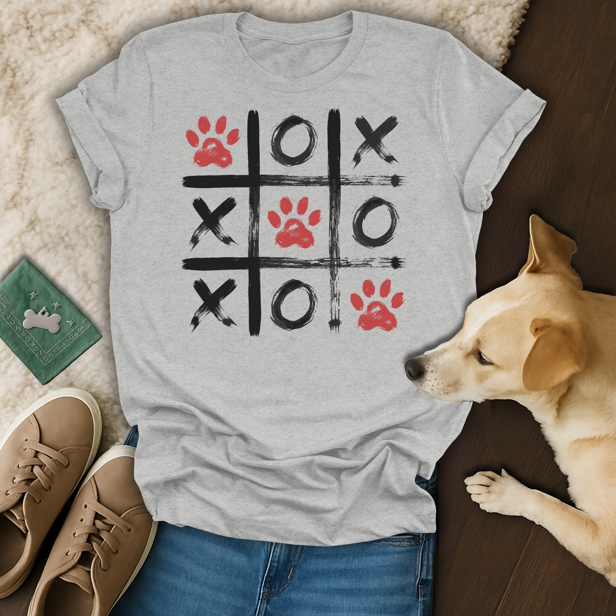 Grey t-shirt with a tic-tac-toe grid featuring red paw prints and black Xs and Os.