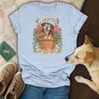 Light blue t-shirt featuring a graphic of a dog in a flower pot with the text I adopted an old soul.