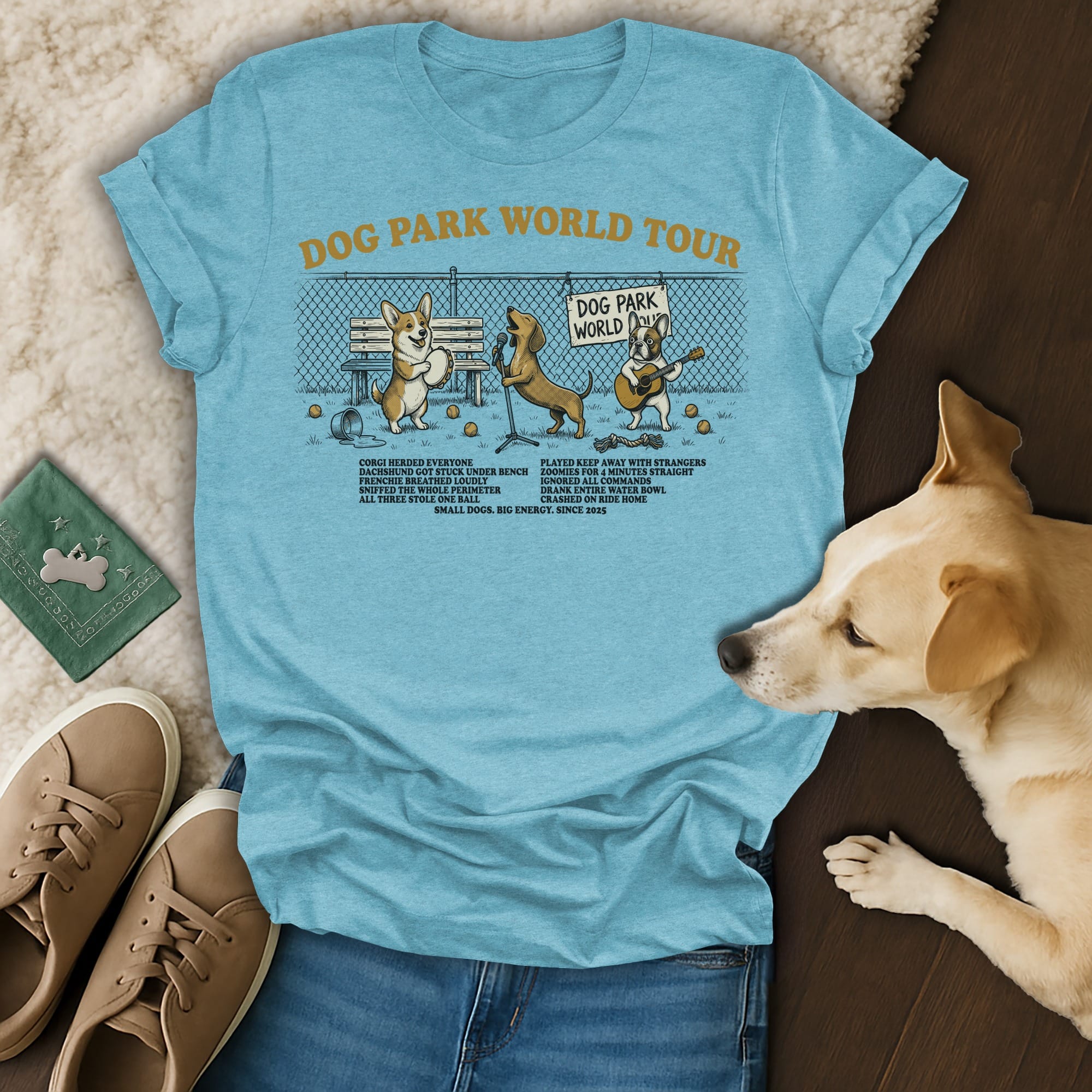 Blue t-shirt with "Dog Park World Tour" text and dog illustrations.