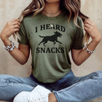 Green t-shirt with black dog silhouette and text "I HEARD SNACKS"