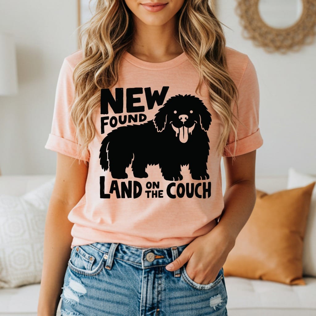 Peach t-shirt with black "New Found Land on the Couch" dog graphic.