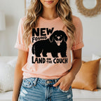 Peach t-shirt with black "New Found Land on the Couch" dog graphic.