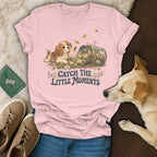 Pink t-shirt with a puppy graphic and the text Catch the Little Moments, surrounded by casual items.