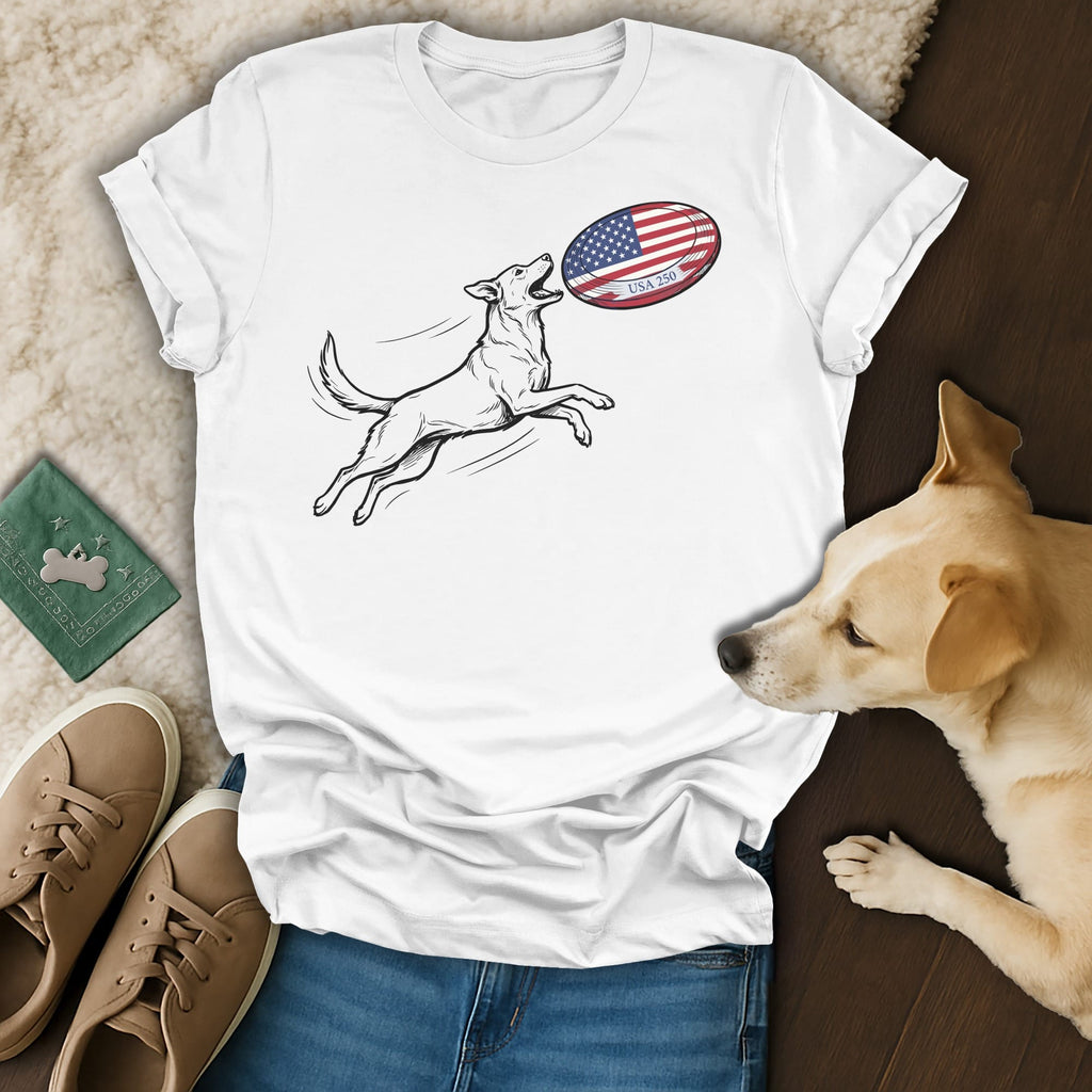 White t-shirt with line drawing of dog catching American flag rugby ball.