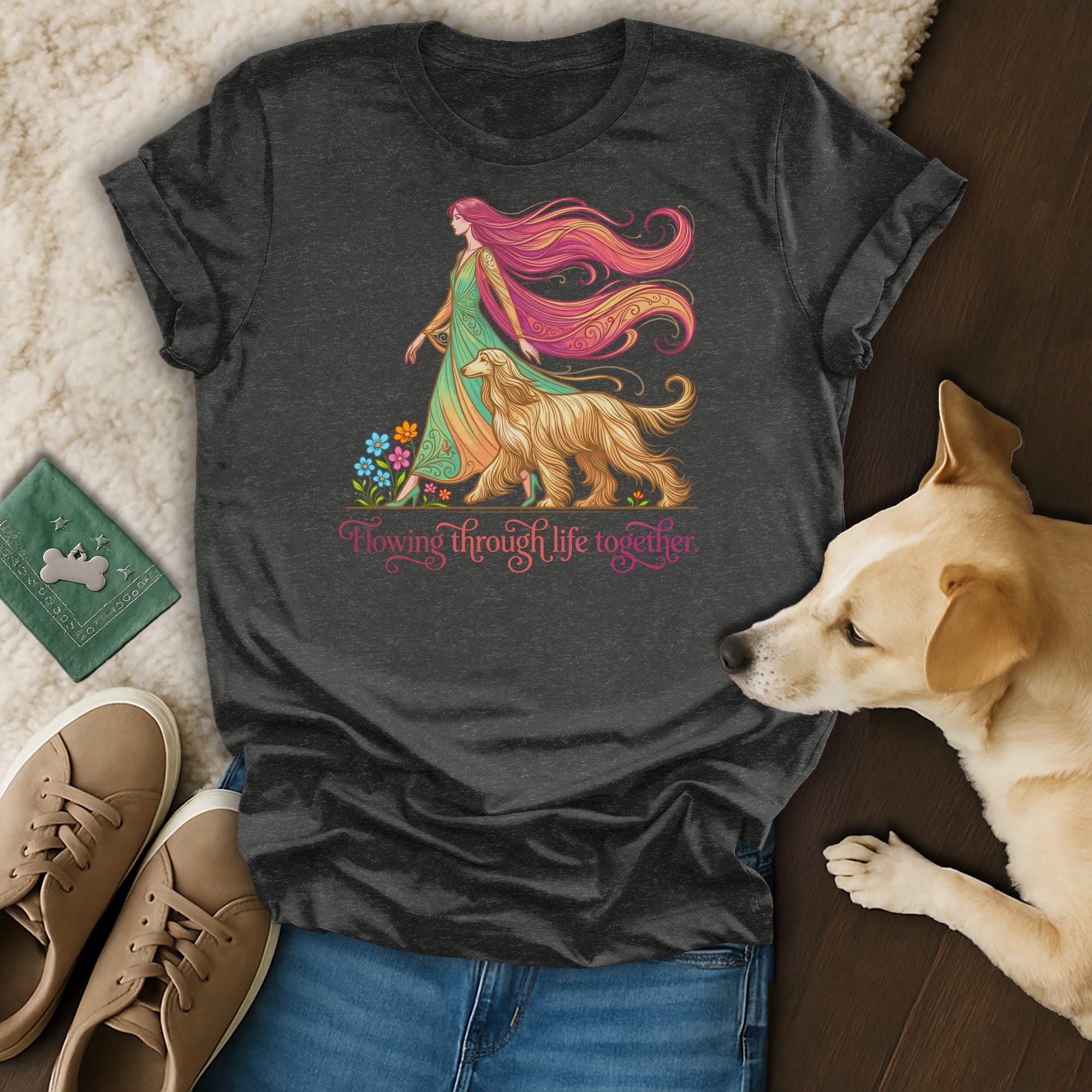 Dark t-shirt with a woman and dog illustration, surrounded by flowers.