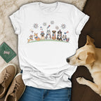 White t-shirt featuring cartoon dogs celebrating with fireworks, wearing patriotic accessories.