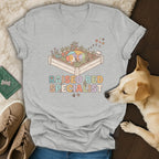 T-shirt with colorful sleeping dog in garden box and "Raised Bed Specialist" text.
