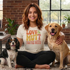 Woman in cream t-shirt with "LOVE THE MUTT YOU'RE WITH" text and two dogs.