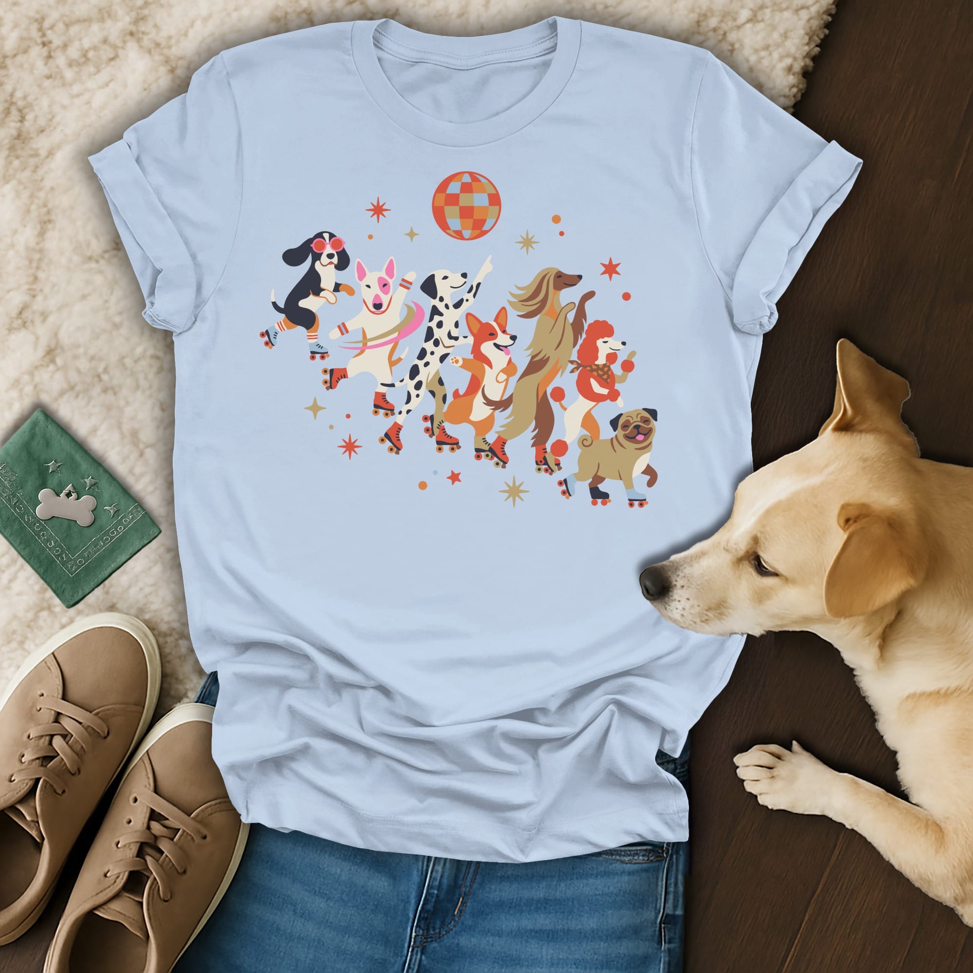Light blue t-shirt with puppies on roller skates dancing under a disco ball.