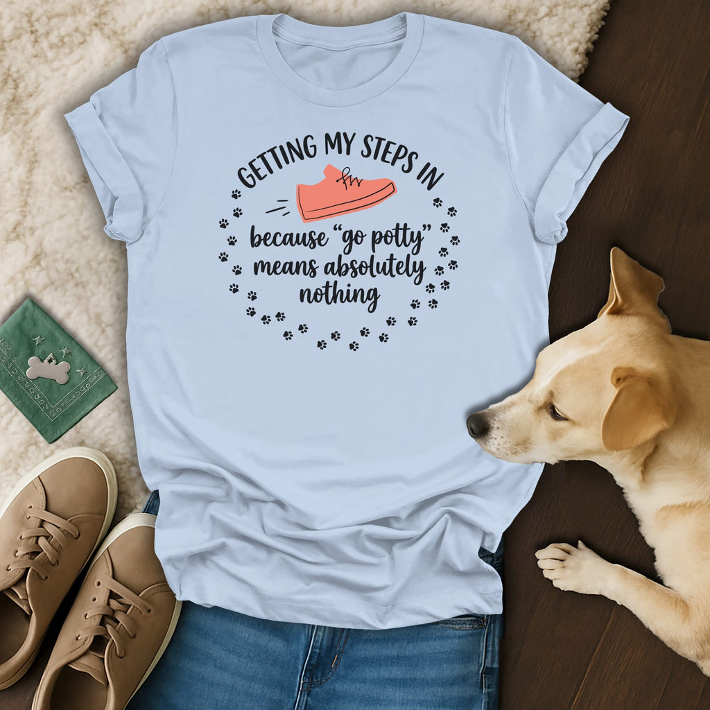 Light blue t-shirt with "Getting my steps in because 'go potty' means absolutely nothing" text.