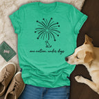 Green t-shirt with fireworks and "one nation, under dogs" text.