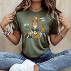 Dogs meditating on mountains with sun and butterflies graphic on olive green shirt.