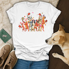 White t-shirt with cartoon dogs playing pickleball, some wearing headbands and sunglasses.