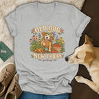 Heather gray v-neck t-shirt featuring a golden retriever gardening graphic with the text OLD DOG NEW TRICKS.