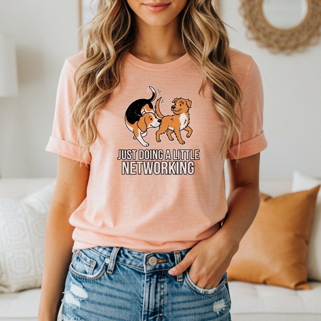 Peach t-shirt with cartoon dogs and the text "JUST DOING A LITTLE NETWORKING".