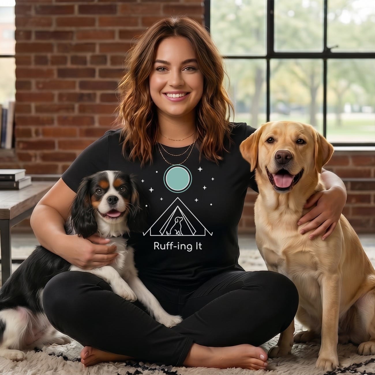 Woman with two dogs, one black and white, one yellow lab, wearing Ruff It shirt.