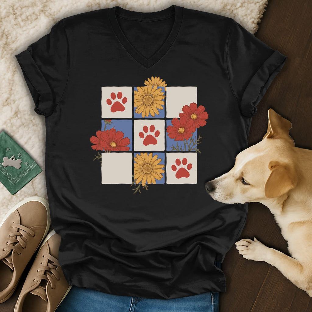 Black t-shirt with a grid design featuring paw prints and floral illustrations.