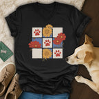 Black t-shirt with a grid design featuring paw prints and floral illustrations.