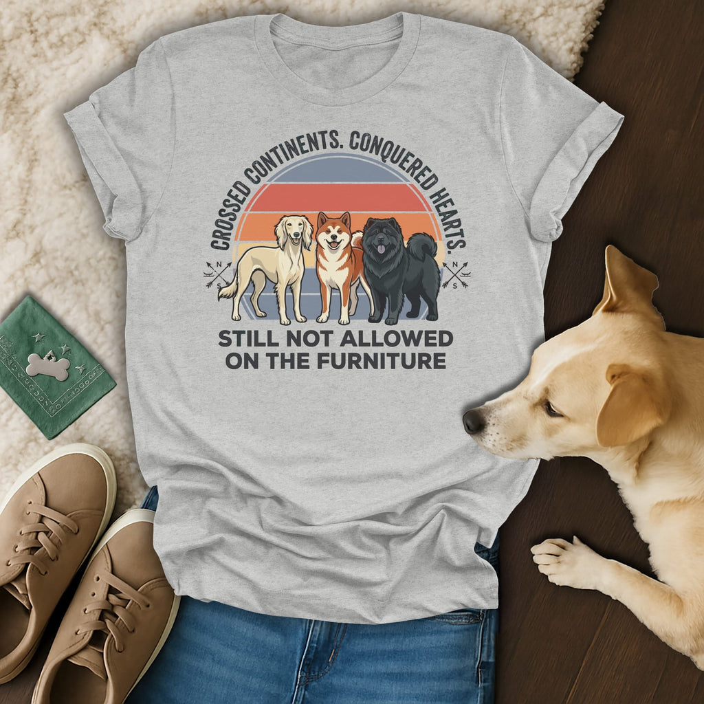 T-shirt with three dogs, text "Crossed Continents. Conquered Hearts. Still Not Allowed On The Furniture."