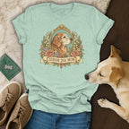 A mint green t-shirt with a vintage-style graphic of a dog inside a floral frame, reading Senior Dog Mom.