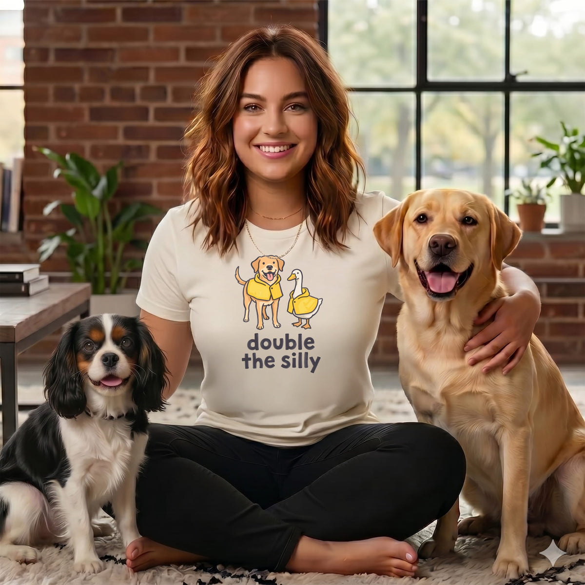 Woman with two dogs and a duck graphic on her shirt reading "double the silly".