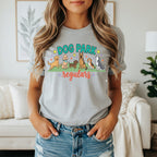 Dog park regulars graphic with dogs and tennis balls on a gray t-shirt.