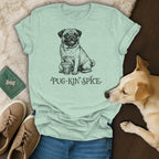 Light blue t-shirt with pug holding a mug and text "PUG-KIN SPICE".