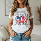 Three dogs hold an American flag banner across their mouths, reading "1776-2026".