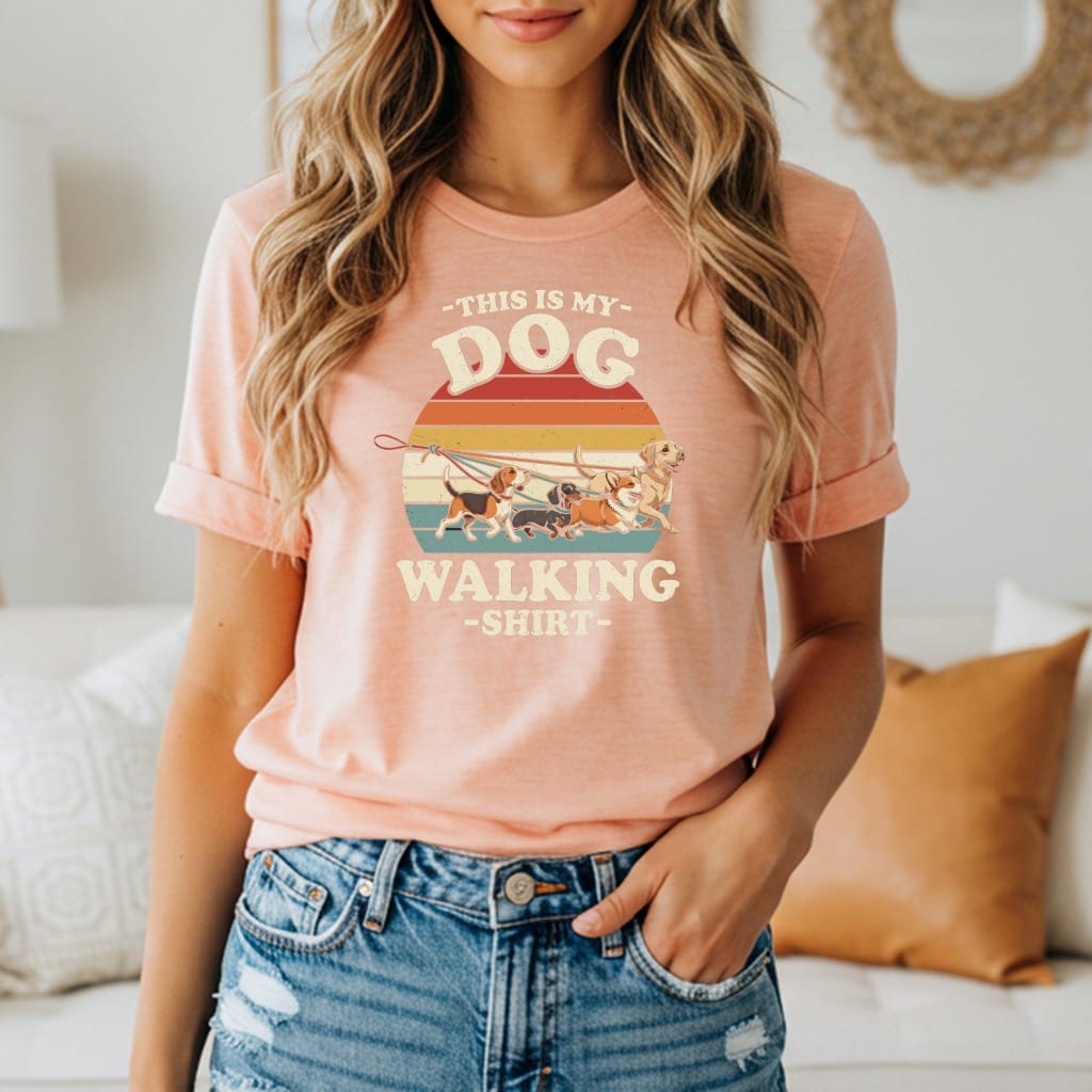Peach t-shirt with "This is my Dog Walking Shirt" graphic and colorful dogs on leashes.