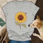 A gray V-neck t-shirt featuring a sunflower graphic with a paw print center and a bee.