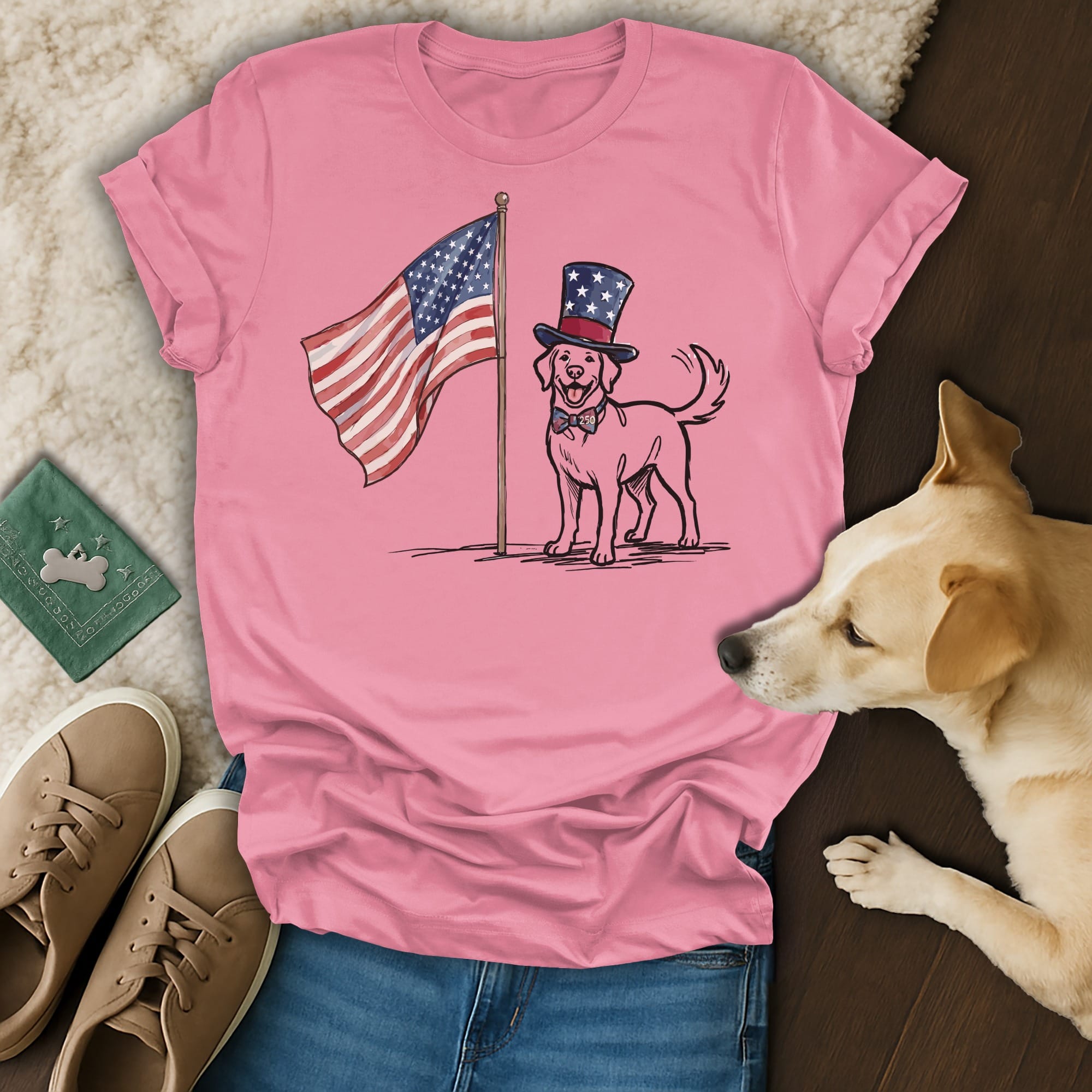 Dog wearing a top hat stands by an American flag on a pink t-shirt.