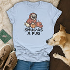 Light blue t-shirt with a pug graphic and the text "SNUG*AS A PUG".