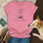 Pink t-shirt with a blue line drawing of a happy pit bull wearing a party hat and holding a balloon, with "PITTY PARTY." text.