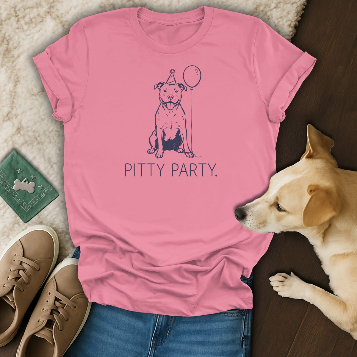 Pink t-shirt with a blue line drawing of a happy pit bull wearing a party hat and holding a balloon, with "PITTY PARTY." text.