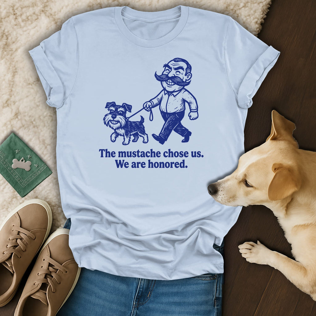 Light blue t-shirt with illustration of a man and dog, text "The mustache chose us. We are honored."