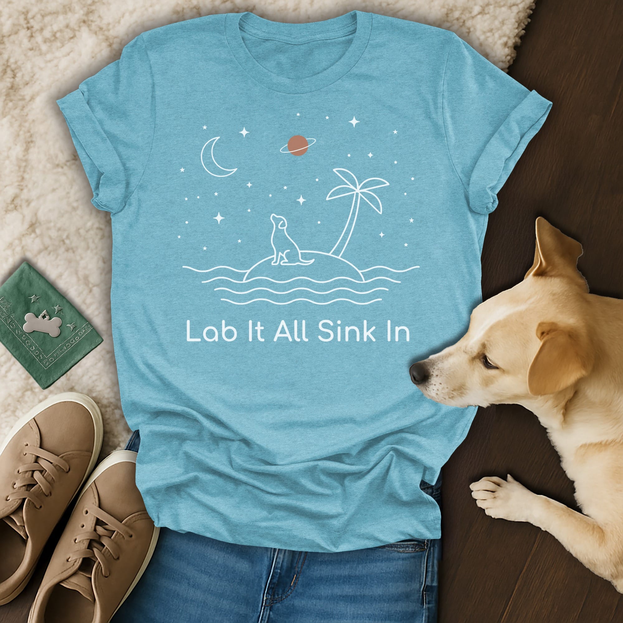 Light blue t-shirt with dog on island and text "Lab It All Sink In".