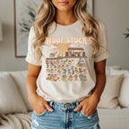 T-shirt graphic with "WOOF STOCK" text and many dogs at a music festival.