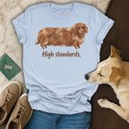Light blue t-shirt with dachshund illustration and text "High standards."