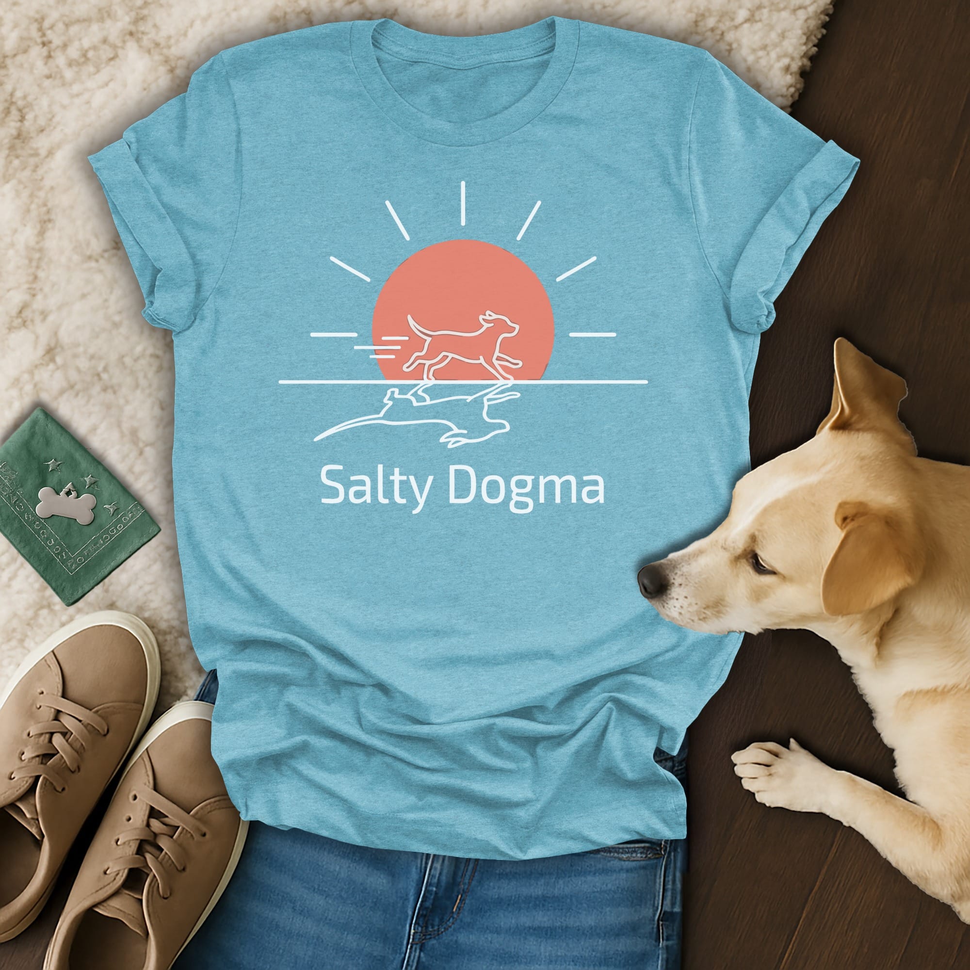 Blue t-shirt with "Salty Dogma" text, sun, and dogs running.
