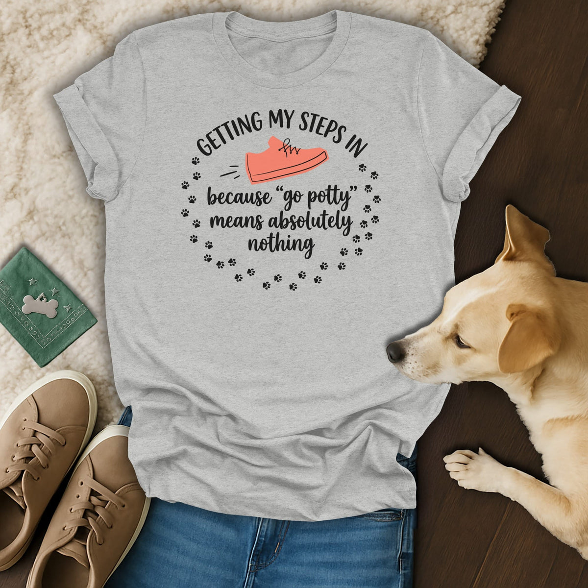 Light grey t-shirt with text "Getting my steps in because "go potty" means absolutely nothing" and a shoe graphic.