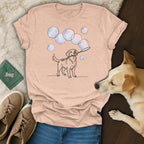 Line drawing of a dog blowing bubbles, on a light pink t-shirt.