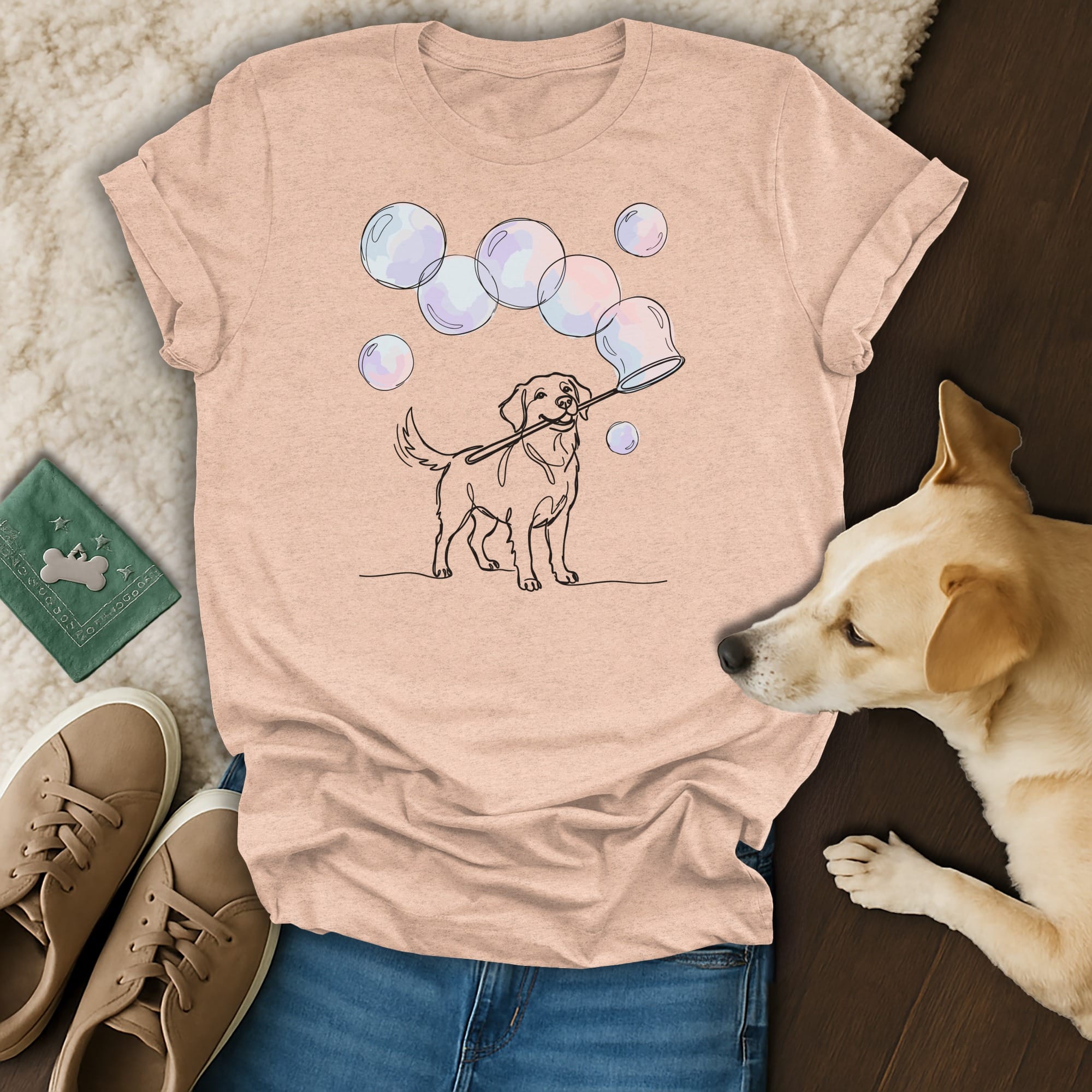 Line drawing of a dog blowing bubbles, on a light pink t-shirt.