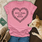 Pink t-shirt with "more dogs, less stress" text inside a heart of paw prints.