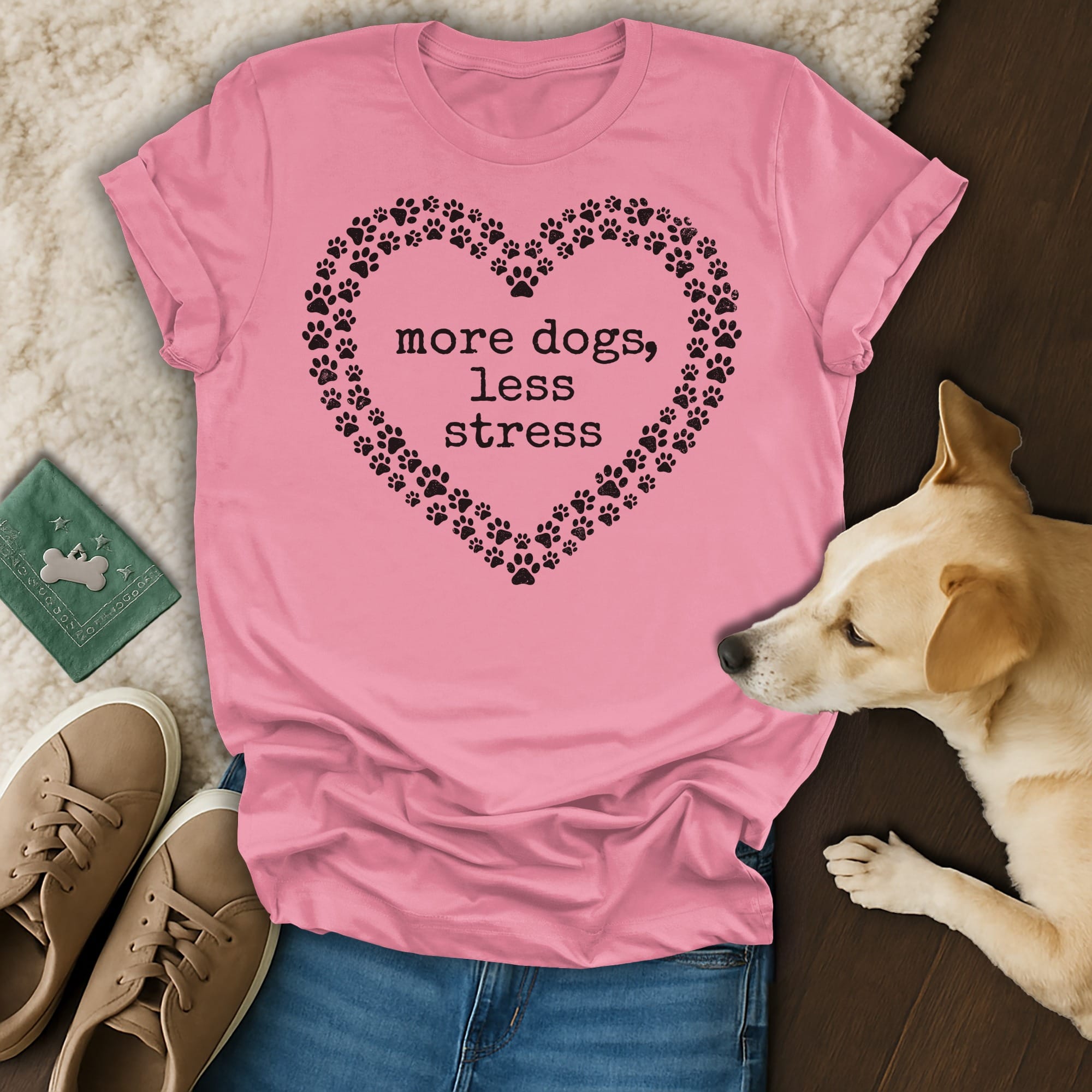 Pink t-shirt with "more dogs, less stress" text inside a heart of paw prints.