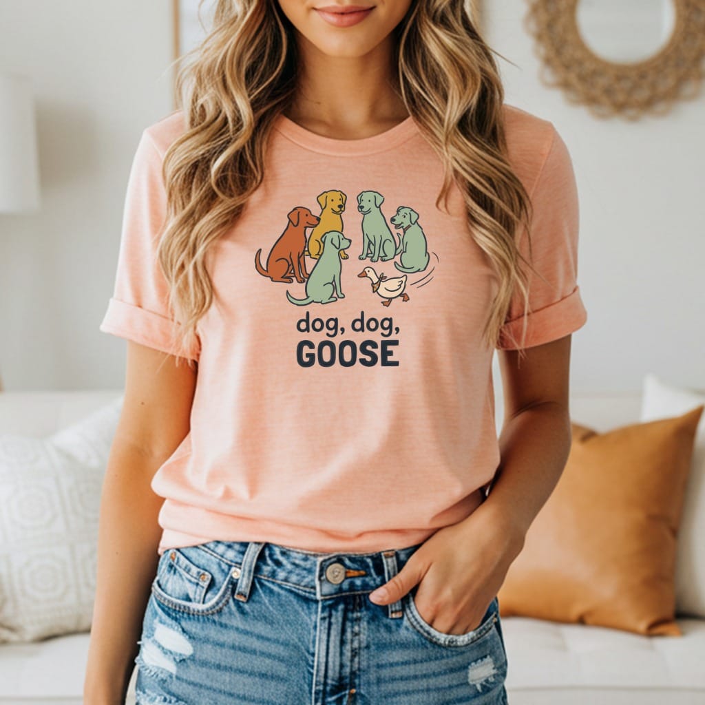 T-shirt with cartoon dogs and a goose, text reads "dog, dog, GOOSE."