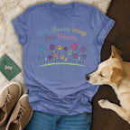 Purple t-shirt with "April Showers Brings Paw Flowers" text and colorful flowers.
