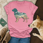 Pink t-shirt with a dog silhouette filled with ocean and beach scene.