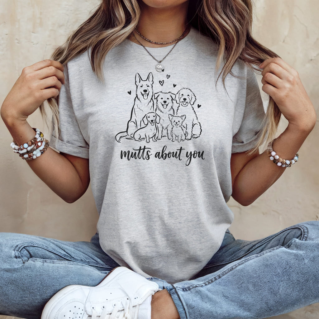 Light grey t-shirt with black line drawing of five dogs and text "mutts about you".