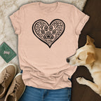 Pink t-shirt with black heart and paw print design, worn by a dog.