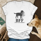 White v-neck t-shirt with black graphic of dog holding toys, text BFF Best Fetch Friend.